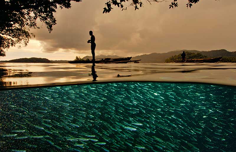 Papuan Fisherman Raja Ampat Indonesia © David Doubilet